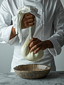 Action shot of a chef making labneh
