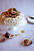 Traditional Australian Pavlova Dessert with Fresh Figs and Served with Honey.