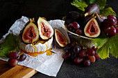 Brie cheese served with figs, honey and grapes.