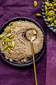 Ground cardamom in a blue bowl