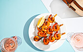 A plate of grilled shrimp skewers for two