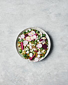 Beetroot and kale salad on a grey background