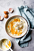 Citrus almond flour poppy seed pancakes in preparation. Hands whisking.