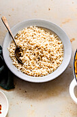 brown basmati rice with a spoon in a white bowl