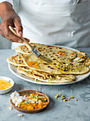 Peshwari naan, smeared with melted butter and sprinkled with apricot, pistachio and coconut.