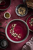 Beetroot soup bowl on red surface