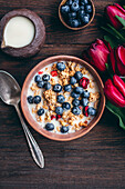 Muesli with cherries and blueberries in a ceramic bowl