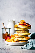 Citrus almond flour poppy seed pancakes, with fresh sliced fruit.