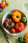 Fresh, colourful tomatoes on a green background