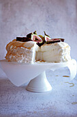 Traditional Australian Pavlova Dessert with Fresh Figs and Served with honey close up.