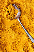 Golden turmeric with a spoon