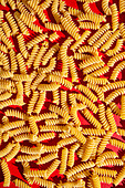 Fusili Pasta Close Up on a red background