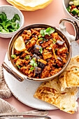 An aubergine bhaji, traditional Indian cuisine served with accompaniments