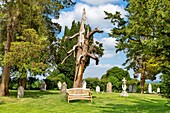 An ancient tree trunk outside the Grade I listed St. Thomas a Becket Church, a redundant Anglican church, in Capel, near Tunbridge Wells, Kent, England, United Kingdom, Europe