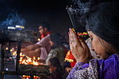 Female worshipper and fire, Kamakhya Temple, Guwahati, Assam, India, Asia