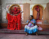 Woman selling flower garlands, Kamakhya Temple, Guwahati, Assam, India, Asia