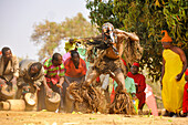 Masked dancer and drummers, The Kulamba Traditional Ceremony of the Chewa people from Zambia, Mozambique and Malawi, held annually on the last Saturday in August to pay homage to their Chief Kalonga Gaia Uni, held near Katete, Eastern Province, Zambia, Africa