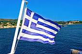 Blue and white Greek flag with cross waving against blue sky, Zakynthos, Ionian Islands, Greek Islands, Greece, Europe