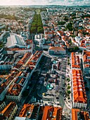 An aerial vertical drone perspective of city center with Rossio Square leading to Restauradores and the tree-lined Avenida da Liberdade boulevard towards Marques de Pombal Square and Eduardo VII Park, Lisbon, Portugal, Europe