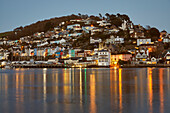 A dusk view of Kingswear, seen from Dartmouth, in the mouth of the River Dart, on the south coast of Devon, England, United Kingdom, Europe