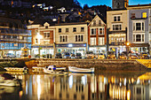 A dusk view of historic buildings around the old harbour at Dartmouth, in the mouth of the River Dart, on the south coast of Devon, England, United Kingdom, Europe