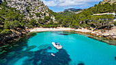 Aerial of a little motorboat in a bay on the Formentor Peninsula, Mallorca, Balearic islands, Spain, Mediterranean, Europe