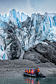 Tourists in Zodiac below the Aguila glacier, Tierra del Fuego, Chile, South America