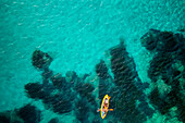 Aerial drone above view of a kayak on the turquoise water of Mediterranean Sea, Sardinia, Italy, Mediterranean, Europe