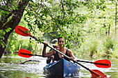 Canoe trip on a branch of the river connecting the lakes Almajas and Asekas around Ginuciai, Aukstaitija National Park, Lithuania, Europe