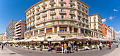 View of pastel coloured architecture, restaurants and cafes on seafront of Via Partenope, Naples, Campania, Italy, Europe