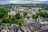 Aerial view of Josselin Castle and the surrounding Sainte Croix medieval quarter in Josselin, Brittany, France. The historic castle and charming rooftops create a picturesque scene.