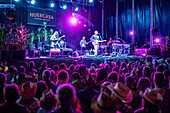 John Hiatt Band performing live at Huercasa Country Festival 2018 in Riaza, Segovia, Spain. Energetic night concert with a vibrant audience.