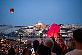 Hot air balloons launching over Luis I bridge and Douro River during Festival of St John of Porto (Festa de São João do Porto ) during Midsummer, on the night of 23 June (Saint John's Eve), in the city of Porto, Portugal