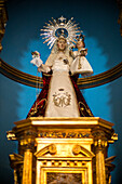 The Nuestra Senora del Manto statue located inside the church in Riaza, Segovia, Spain, showcasing intricate religious art from the 15th century.