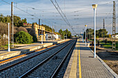 Peaceful view of an empty railway station in the town of Carrion de los Cespedes, Sevilla, Andalusia, Spain, during a sunny day.