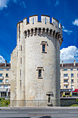 Ancient stone King William Tower located in Caen, Normandy, France. Clear blue sky and urban background with surrounding buildings.