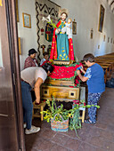 Parishioners prepare religious statues and icons in the church for the procession on Saint Joseph's Day in Cachi, Argentina.