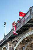 Sevilla FC fans mark the 2007 UEFA Cup victory with celebrations on Triana Bridge, Sevilla, Andalusia, Spain.