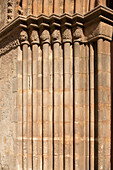 Close up of the Mudejar Gothic architectural details on the Church of San Marcos, Seville, Spain. Features intricate stone carvings and historic design.