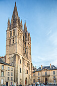 The historic Men’s Abbey in Caen showcases Gothic spires against a serene sky.