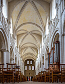 Interior view of the historical Abbaye aux Dames in Caen, showcasing its remarkable arches and peaceful atmosphere.