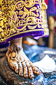 Intricate close up of the robes and foot of Nuestro Padre Jesus Nazareno, a 17th-century statue from Semana Santa de Sevilla, Spain.