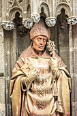 A detailed view of the terracotta statue of San Laureano by Mercadante de Bretaña (15th century), located at the Baptism Gate in Seville Cathedral, Spain.