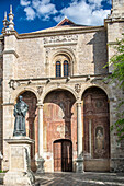 The facade of the 16th-century Iglesia de Santo Domingo in Granada, Andalusia, Spain, showcasing its classic architecture and historic statues.