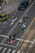 Group of tourists riding scooters, view from above, Prague