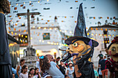 A lively celebration in Fuenteheridos, Huelva, featuring the traditional Gigantes y Cabezudos parade. Families gather to enjoy the festivities and colorful costumes.