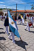 A woman carries an Argentine flag in the procession on Saint Joseph's Day in Cachi, Argentina.