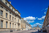 Scenic view of Saint Sauveur Square, historic buildings and streets in Caen, Normandy, France under a bright blue sky with scattered clouds.