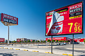 Image of a Bricodepot hardware store and billboard in Seville, Spain, highlighting contemporary architecture and signage.