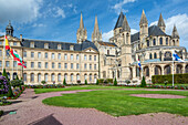 View of the historic City Hall and Men's Abbey in Caen, Normandy, France on a sunny day. Stunning architecture and beautiful garden.